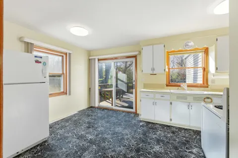a spacious bathroom with a granite countertop sink and a window