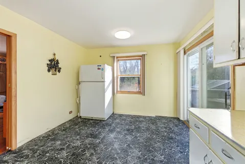 a view of a kitchen with a sink and refrigerator