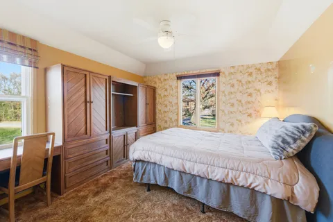 a bedroom with a large bed and a window