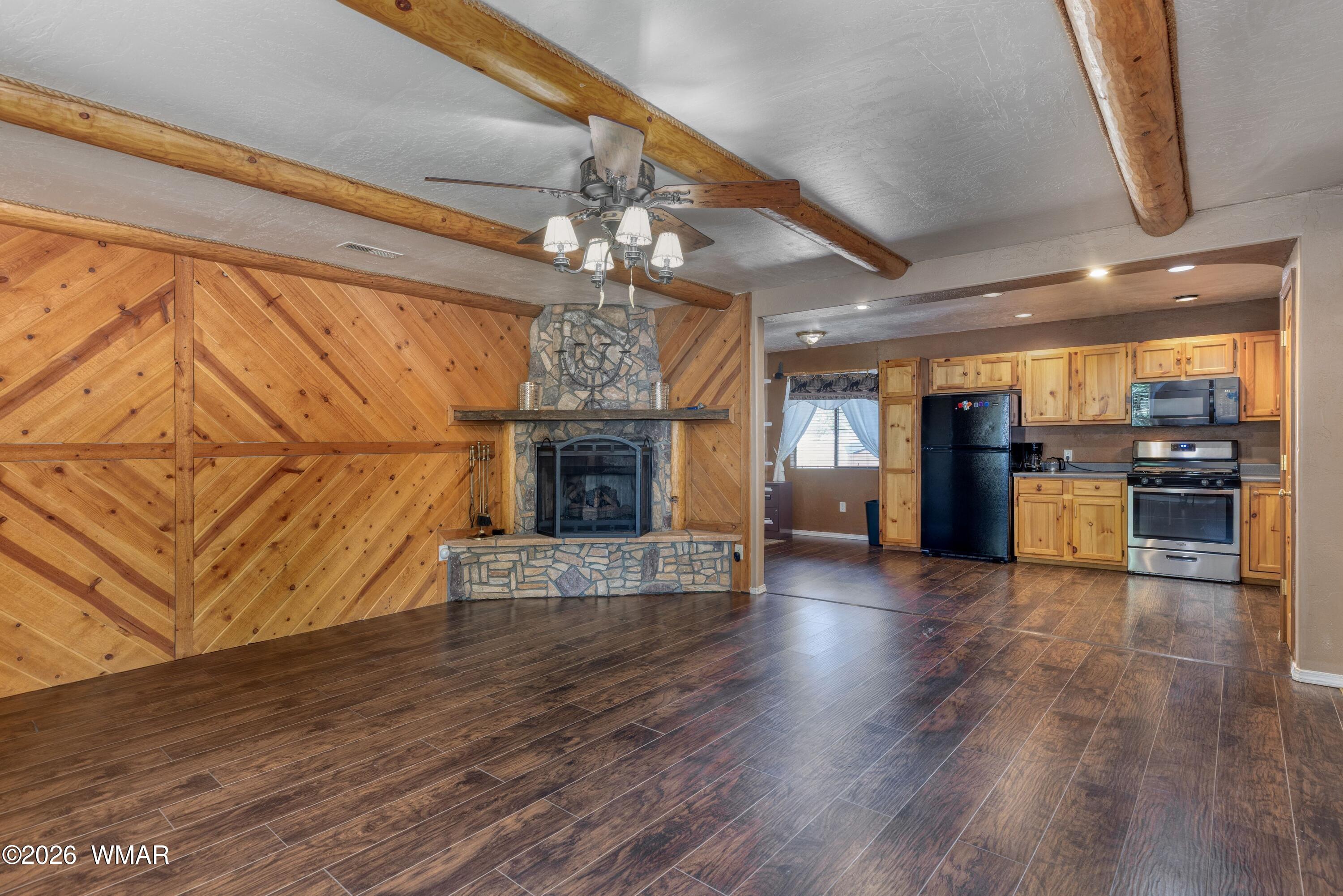 2722 Bain Trail Overgaard, AZ 85933 - Photo 2 of 28 a view of empty room with wooden floor and fireplace