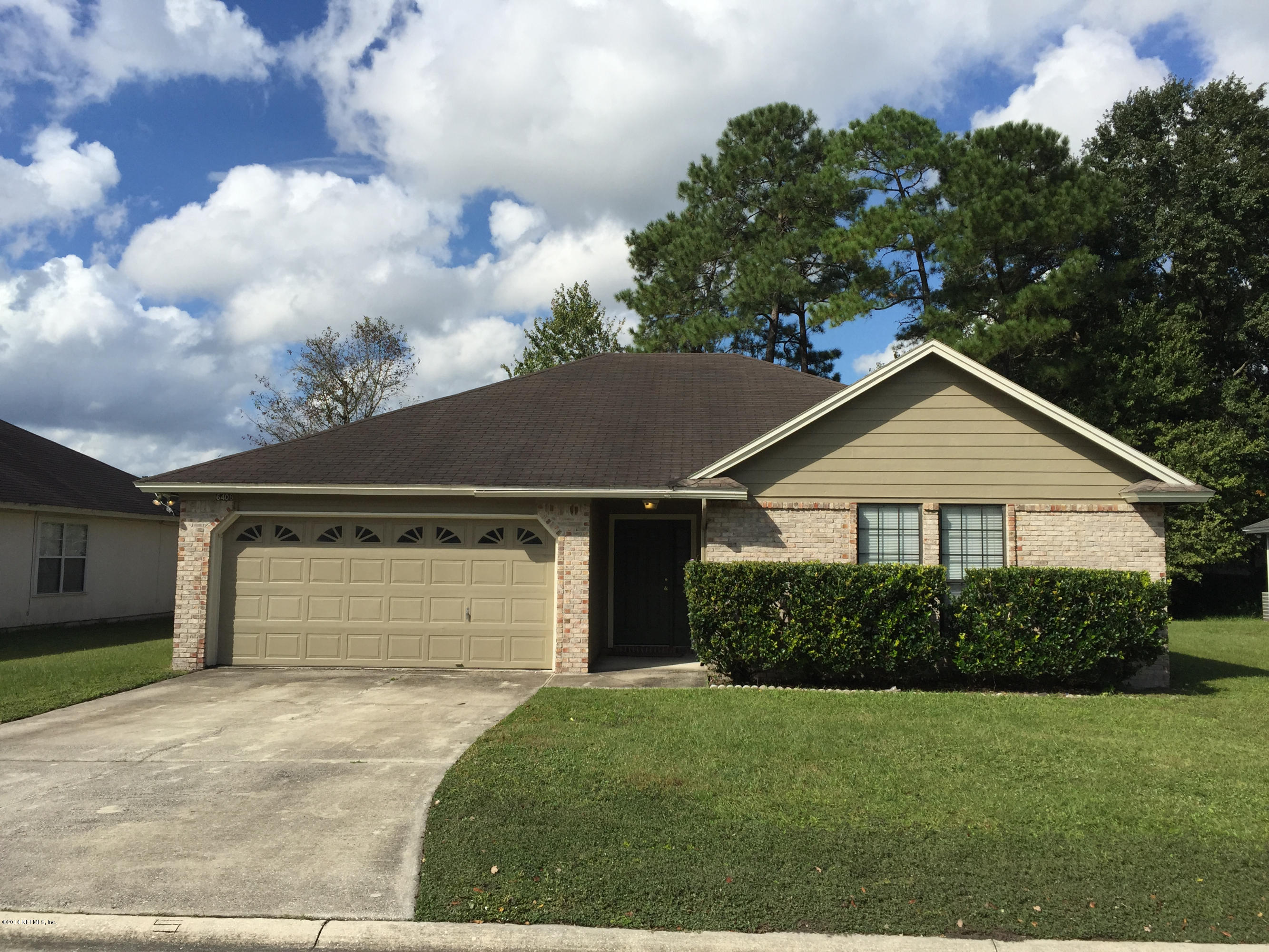 6408 Checkmate Lane Jacksonville, FL 32244 - Photo 1 of 18 a front view of a house with a yard and garage
