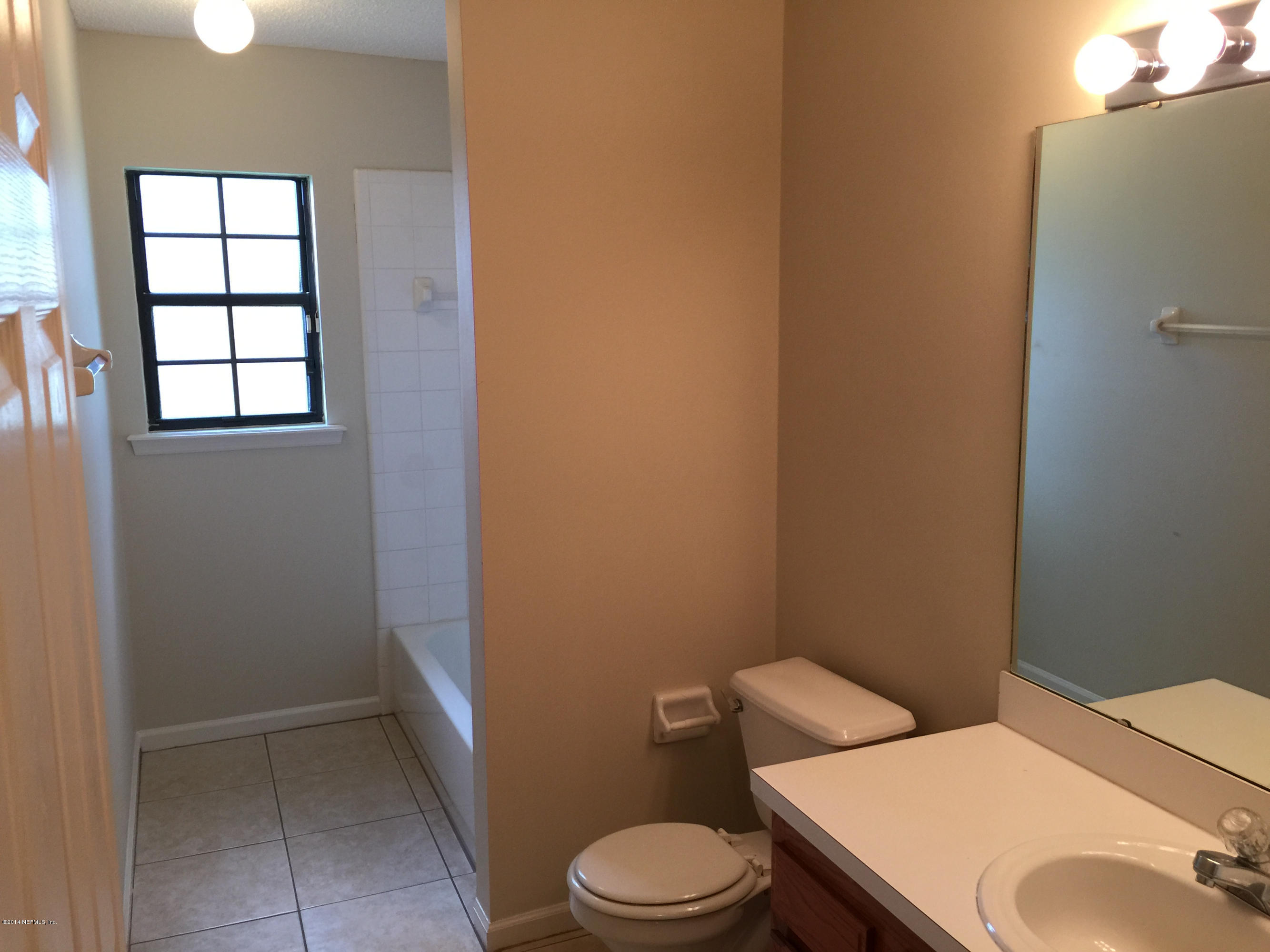 6408 Checkmate Lane Jacksonville, FL 32244 - Photo 12 of 18 a white toilet sitting next to a bathroom sink