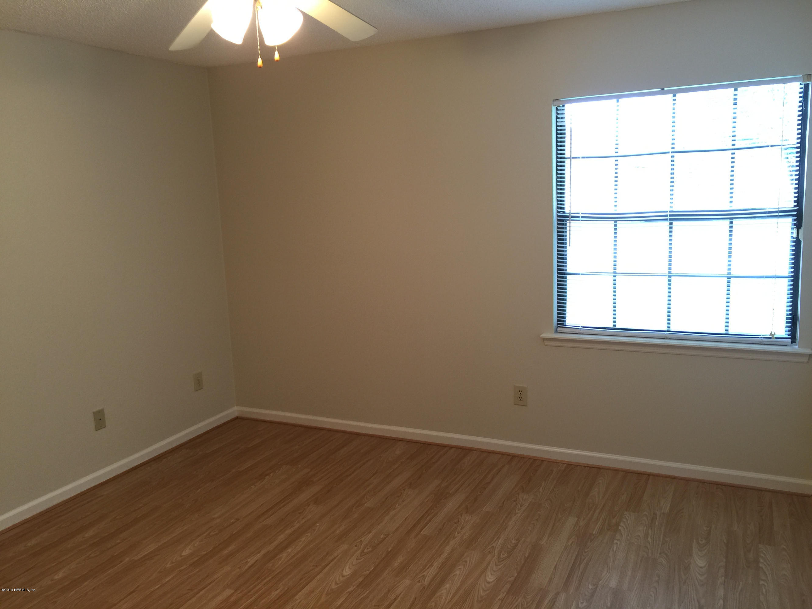 6408 Checkmate Lane Jacksonville, FL 32244 - Photo 14 of 18 an empty room with a window