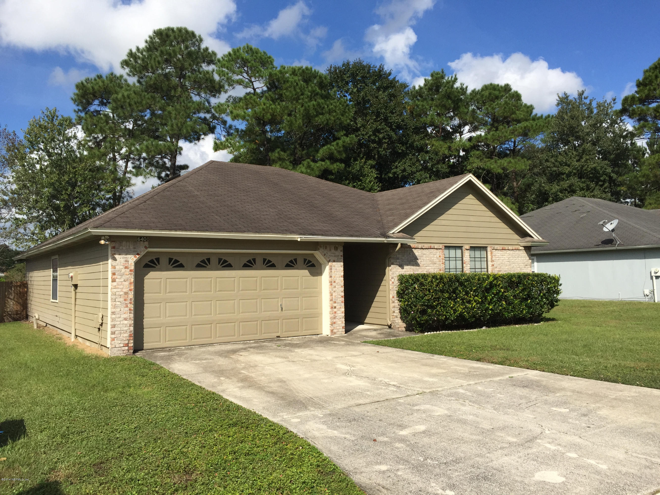 6408 Checkmate Lane Jacksonville, FL 32244 - Photo 2 of 18 a front view of a house with a yard and garage