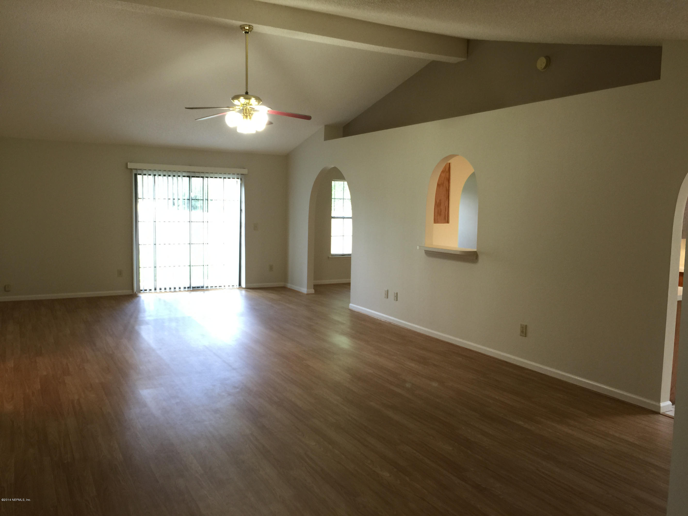 6408 Checkmate Lane Jacksonville, FL 32244 - Photo 4 of 18 a view of a room with wooden floor and windows