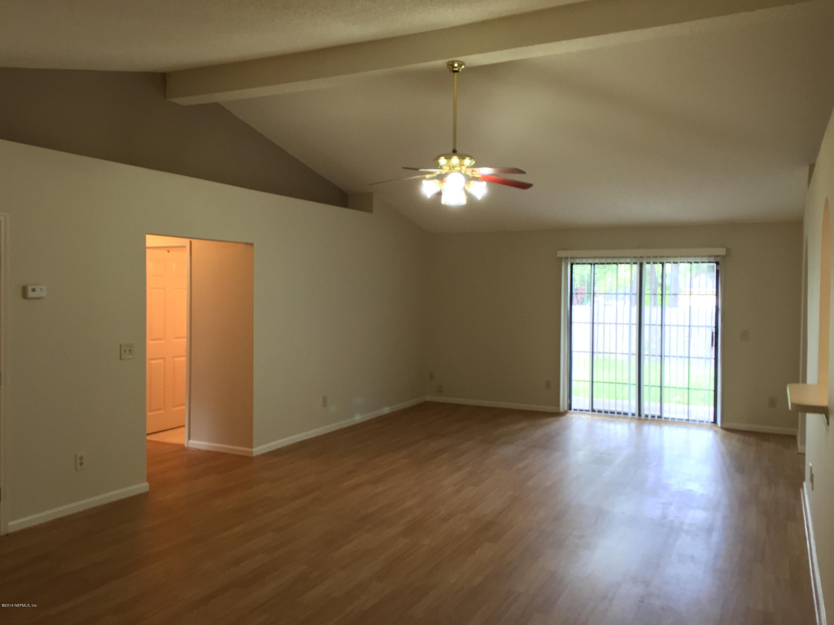 6408 Checkmate Lane Jacksonville, FL 32244 - Photo 5 of 18 a view of a livingroom with a chandelier wooden floor and a window