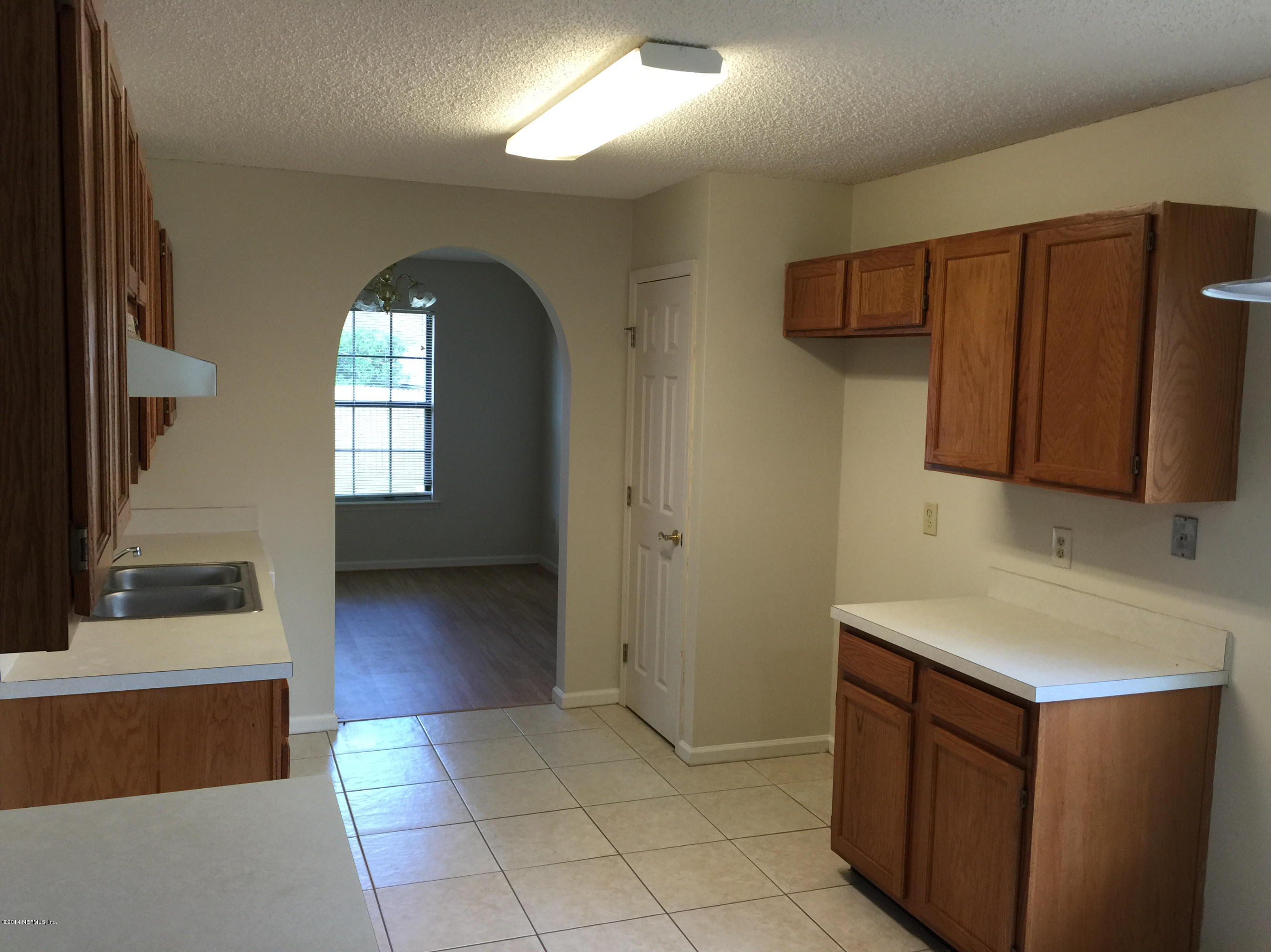 6408 Checkmate Lane Jacksonville, FL 32244 - Photo 6 of 18 a kitchen with a sink and cabinets