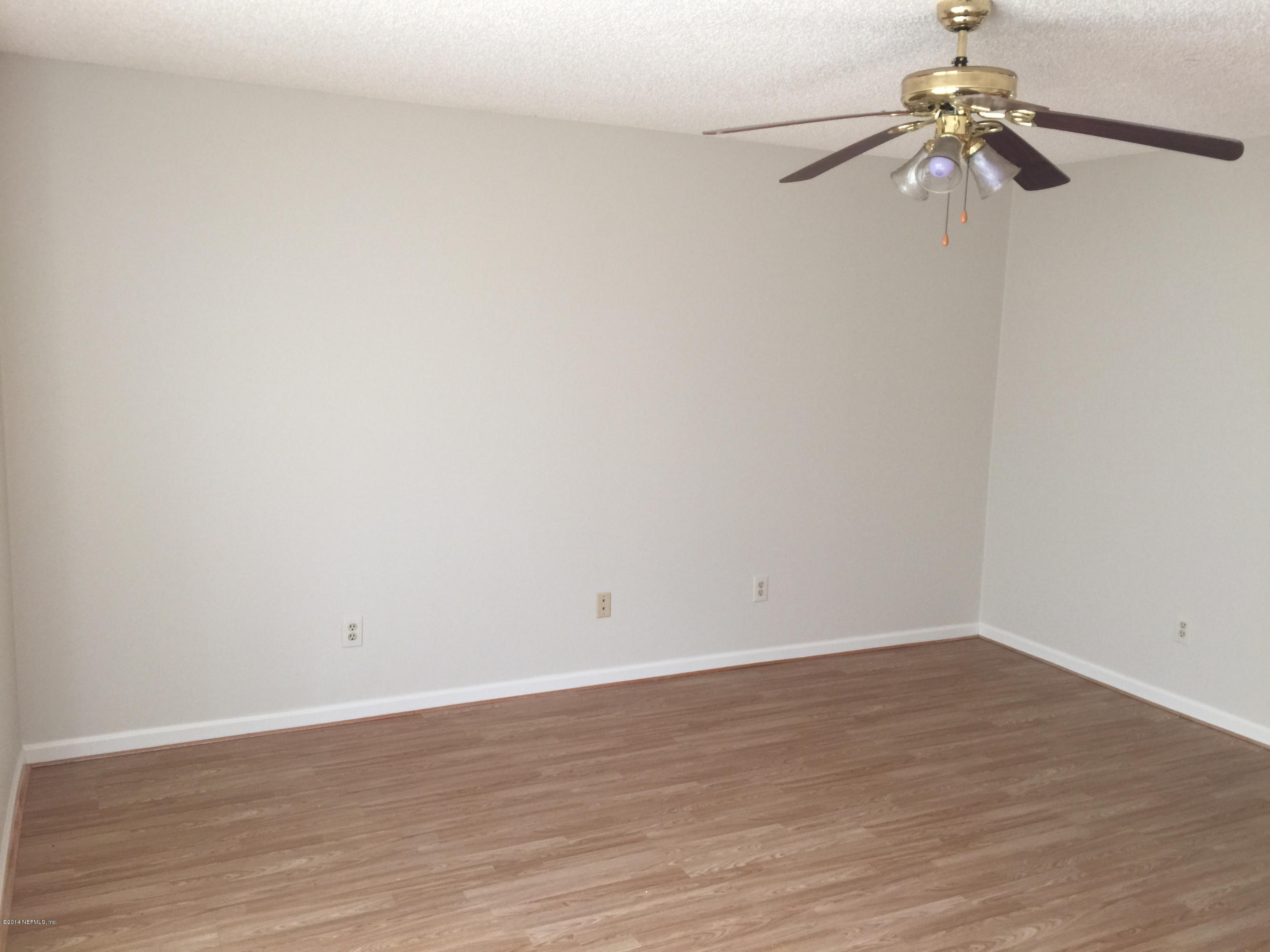 6408 Checkmate Lane Jacksonville, FL 32244 - Photo 10 of 18 a view of an empty room with a fan