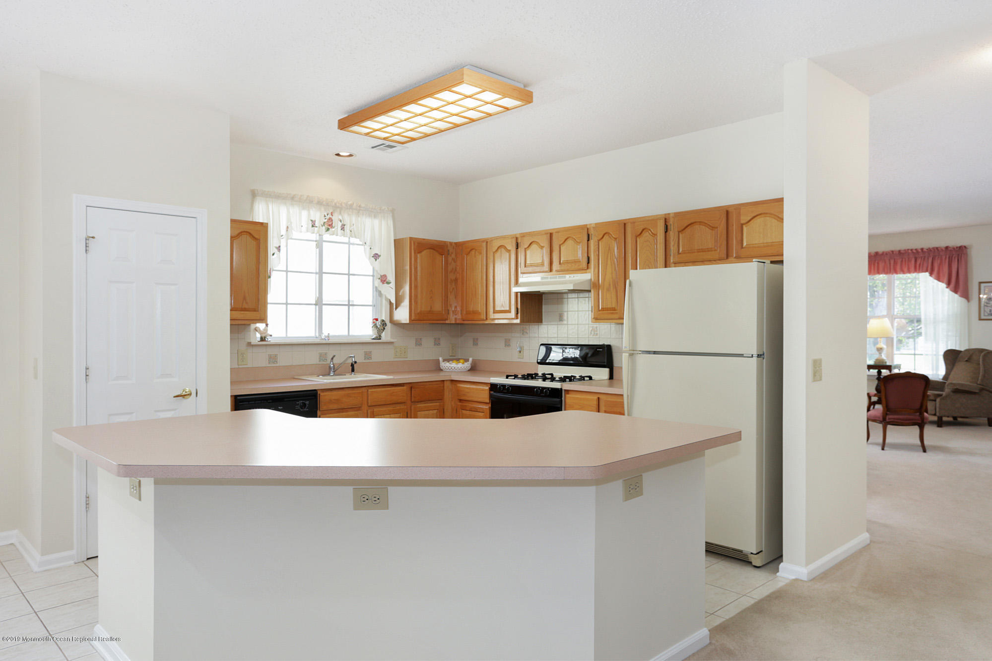 60 Quail Road Barnegat, NJ 08005 - Photo 8 of 23 a kitchen with stainless steel appliances a refrigerator a sink a stove a dining table and chairs