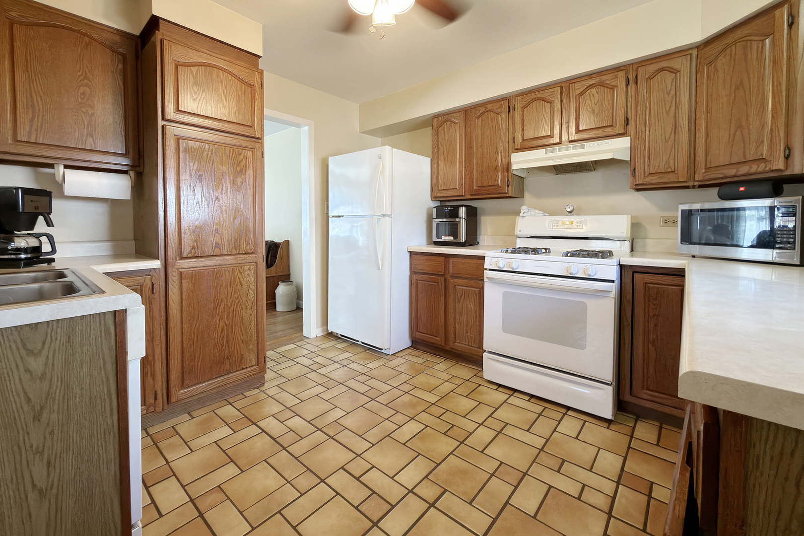 62 Mayer Avenue Wheeling, IL 60090 - Photo 5 of 20 a kitchen with a refrigerator sink and cabinets