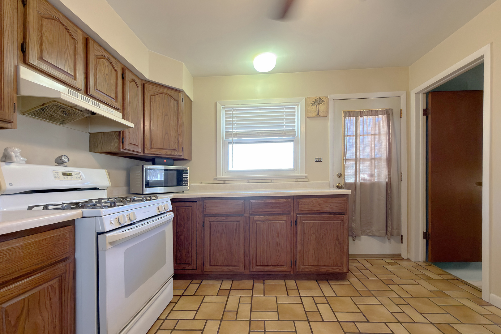 62 Mayer Avenue Wheeling, IL 60090 - Photo 6 of 20 a kitchen with stainless steel appliances granite countertop a stove a sink and a refrigerator