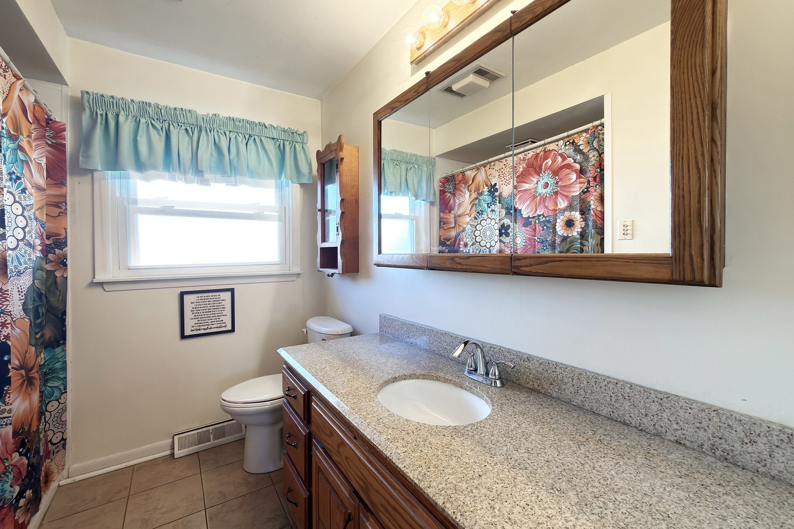 62 Mayer Avenue Wheeling, IL 60090 - Photo 10 of 20 a bathroom with a granite countertop sink and a mirror