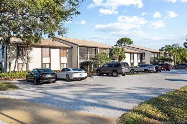 a view of a cars park in front of a house