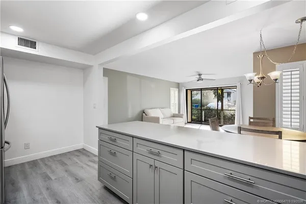a view of center island cabinets and a sink