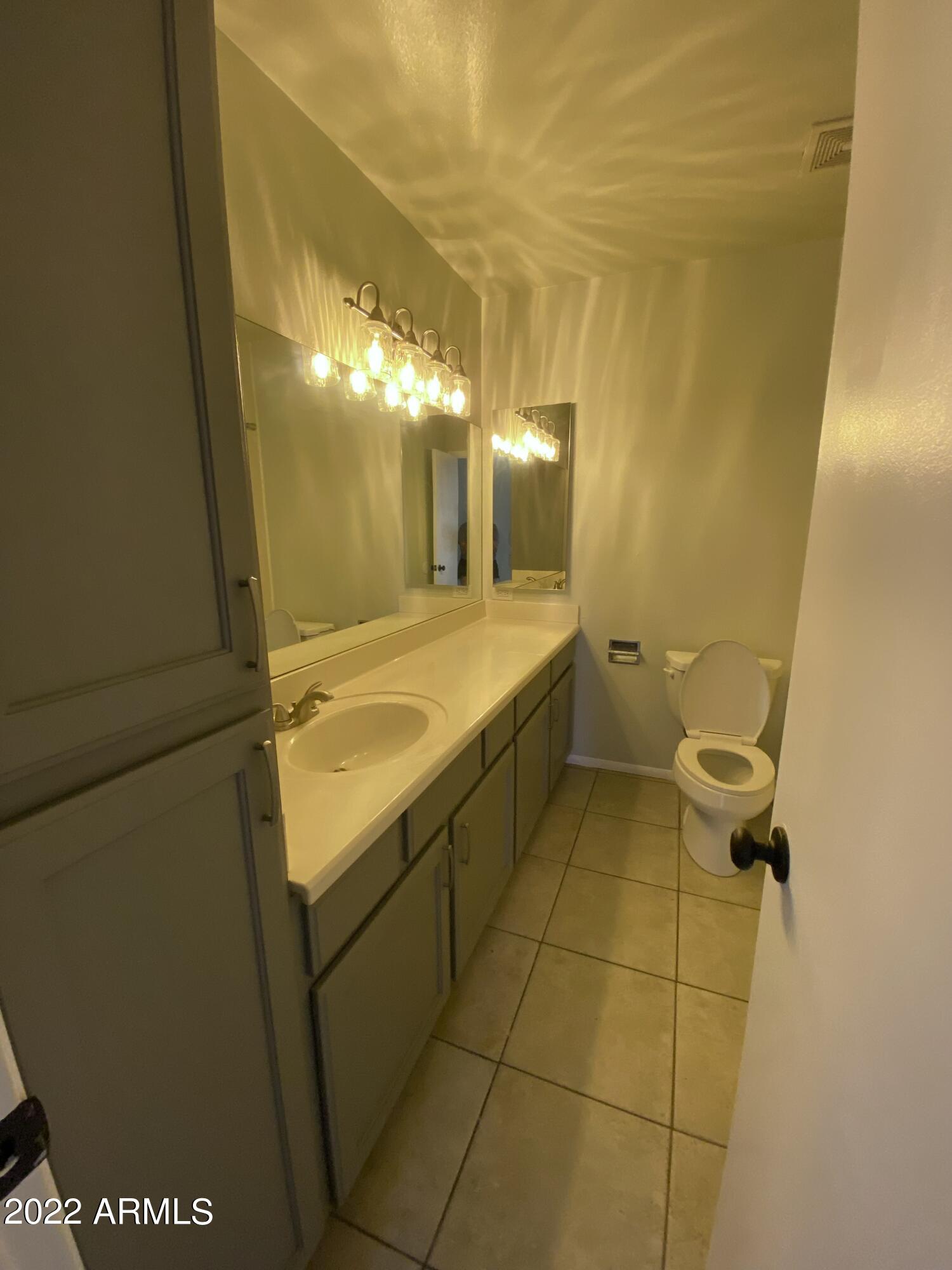 3244 West Yucca Street Phoenix, AZ 85029 - Photo 9 of 21 a bathroom with a sink and mirror