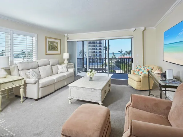 a dining room with furniture and a large window