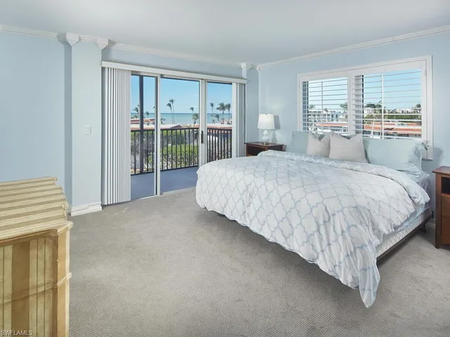 a bedroom with a large bed and window