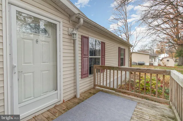 a view of a wooden house with a bench