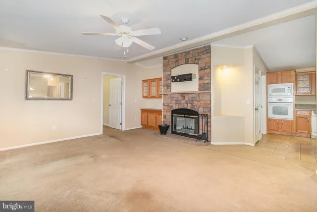 a view of an empty room with a fireplace