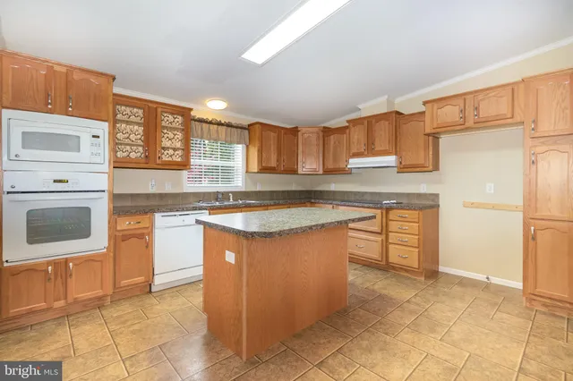a kitchen with stainless steel appliances granite countertop a stove refrigerator sink and cabinets