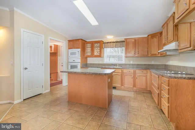 a kitchen with stainless steel appliances granite countertop a refrigerator sink and cabinets