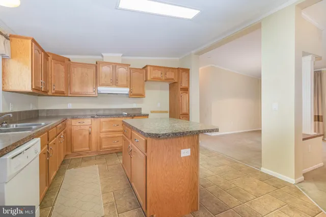 a kitchen with granite countertop a sink and a stove