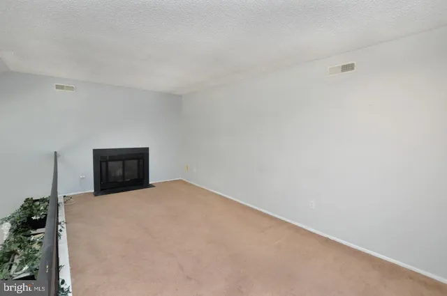 a view of a livingroom with an empty space and a window