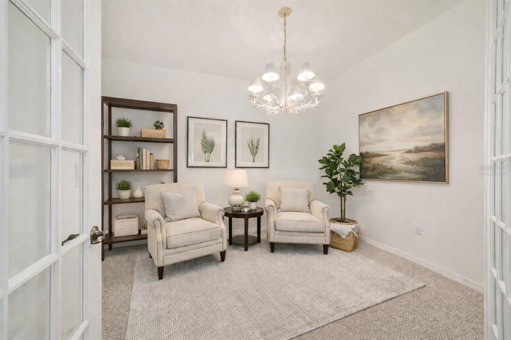 8434 Southwest 82nd Loop Ocala, FL 34481 - Photo 12 of 41 a living room with furniture and a chandelier