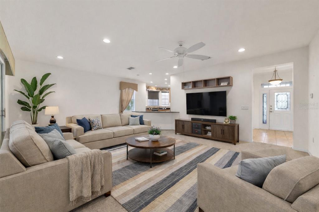 8434 Southwest 82nd Loop Ocala, FL 34481 - Photo 13 of 41 a living room with furniture and a flat screen tv