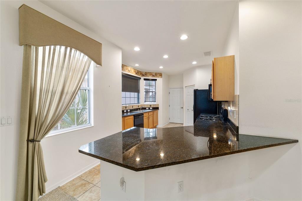 8434 Southwest 82nd Loop Ocala, FL 34481 - Photo 16 of 41 a kitchen with stainless steel appliances granite countertop a sink a stove and a refrigerator