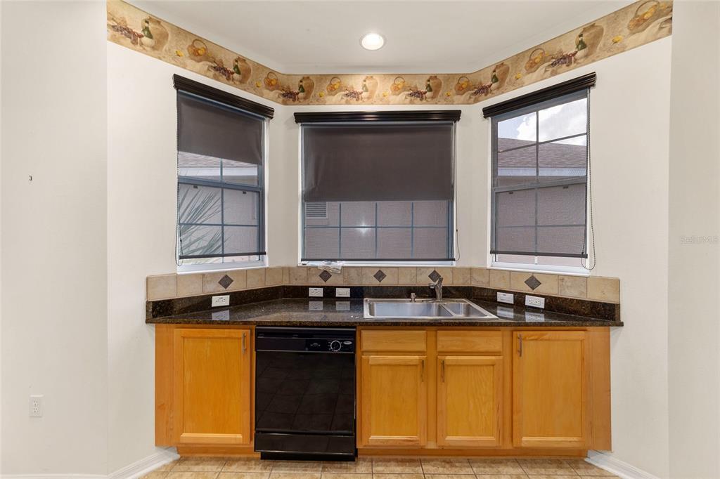 8434 Southwest 82nd Loop Ocala, FL 34481 - Photo 20 of 41 a view of a kitchen with granite countertop a sink and a stove