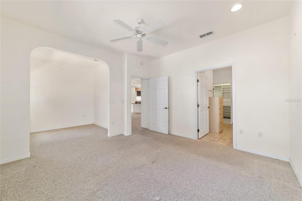 8434 Southwest 82nd Loop Ocala, FL 34481 - Photo 23 of 41 an empty room with a ceiling fan and closet area