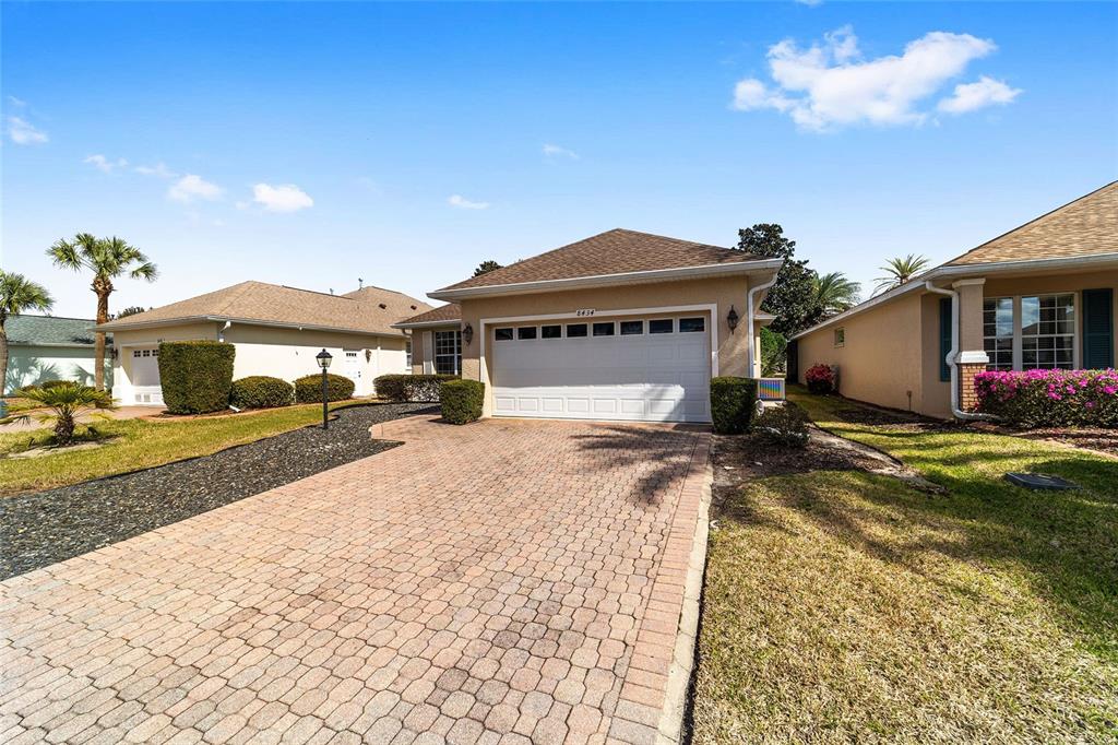 8434 Southwest 82nd Loop Ocala, FL 34481 - Photo 3 of 41 a front view of a house with a yard and balcony