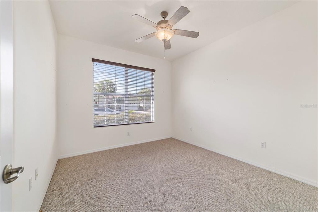 8434 Southwest 82nd Loop Ocala, FL 34481 - Photo 31 of 41 an empty room with a window and a fan