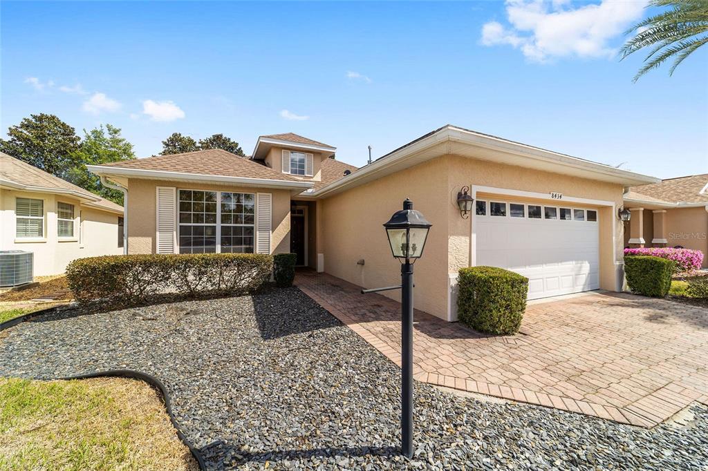 8434 Southwest 82nd Loop Ocala, FL 34481 - Photo 5 of 41 a front view of a house with a yard