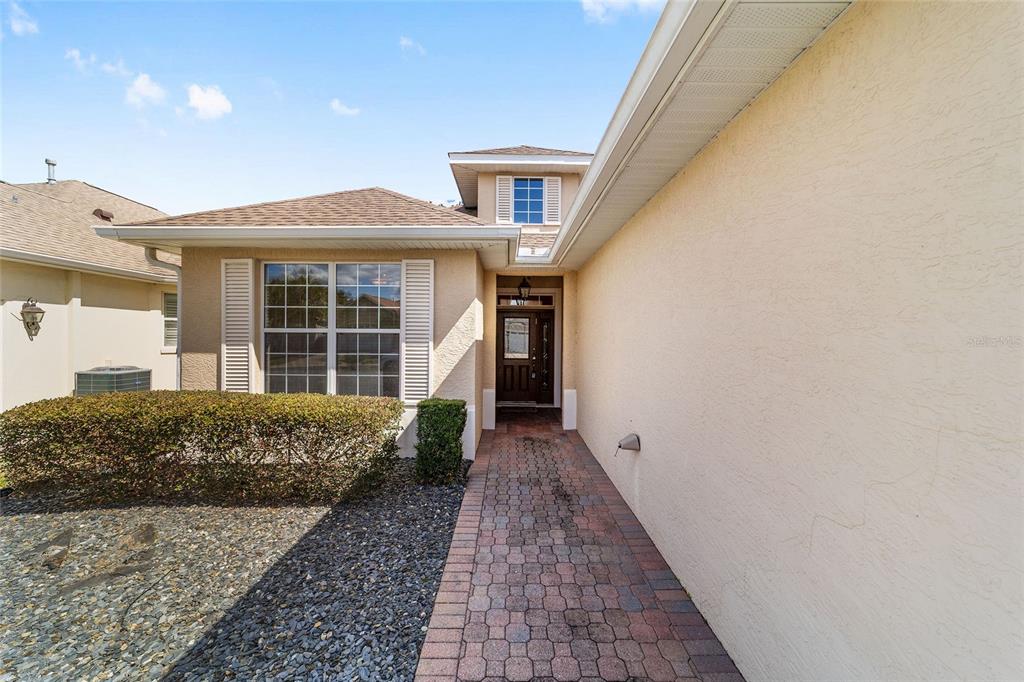 8434 Southwest 82nd Loop Ocala, FL 34481 - Photo 8 of 41 a front view of a house with a garden