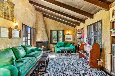 a view of living room filled with furniture and windows
