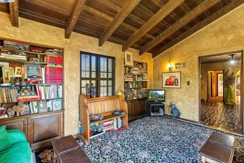 a living room with furniture and a book shelf