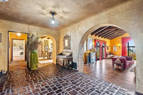 a living room with fireplace furniture and a chandelier