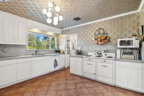a kitchen with cabinets a sink and appliances