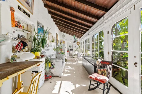 a building outdoor space with patio furniture and potted plants