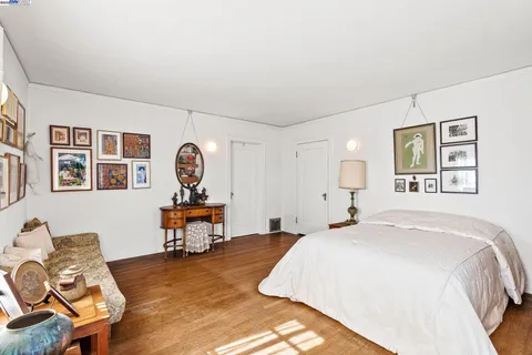 a view of a hallway with wooden floor and entryway
