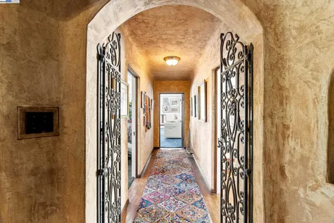 a living room with baby bed furniture and a chandelier