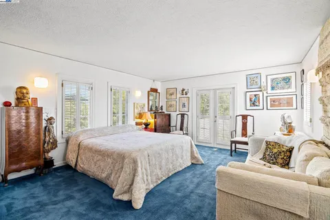 a bedroom with a large bed and a couch