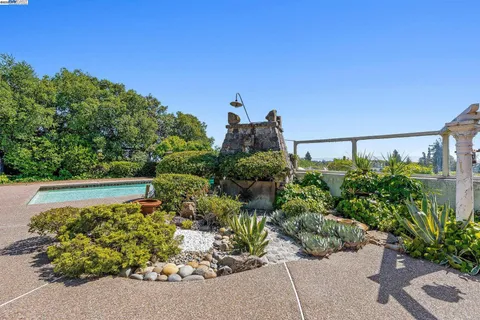 a front view of a house with yard and outdoor seating
