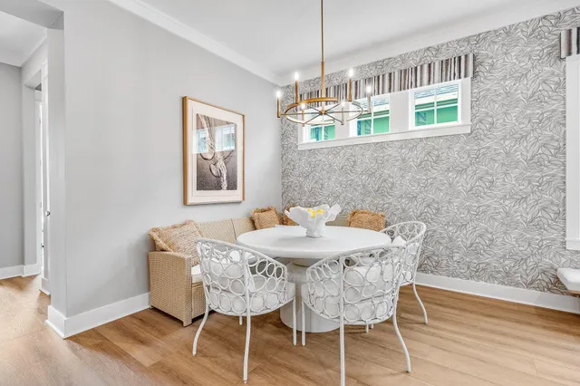a view of a dining room with furniture wooden floor and chandelier