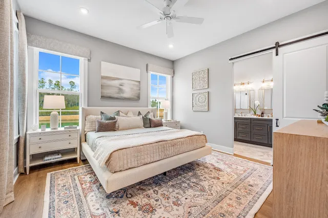a bedroom with a large bed and a chandelier