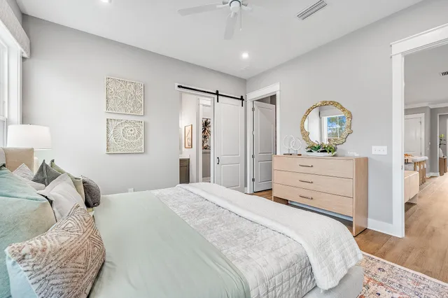 a bedroom with a bed and a chandelier