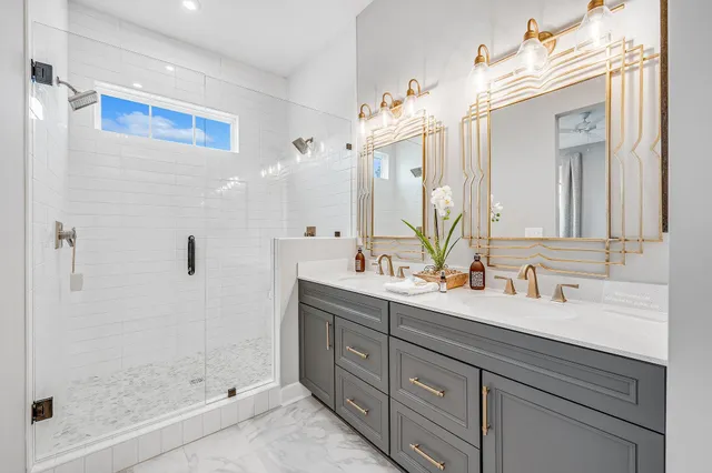 a bathroom with a double vanity sink mirror and shower
