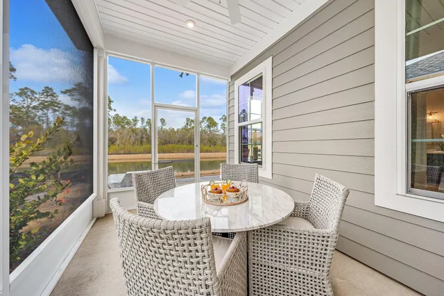 a view of a dining room with a table and chairs